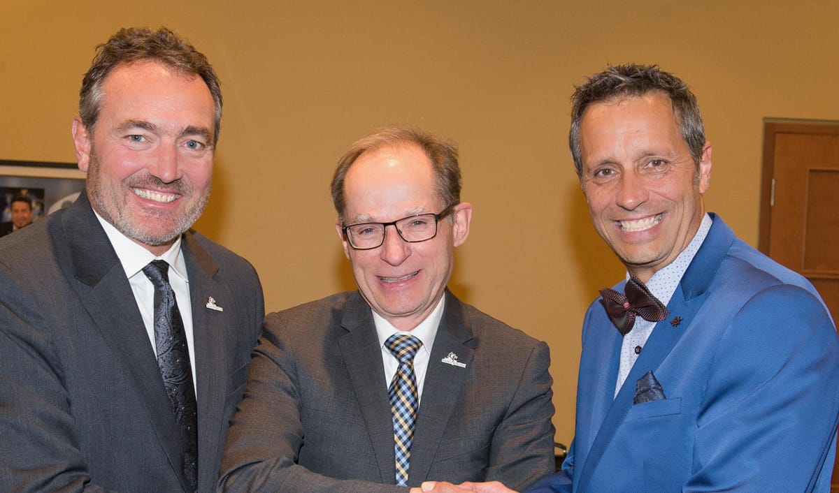 Le maire Maher, avec un noeud papillon, posant aux côtés du directeur général de Saint-Jérôme Yvan Patenaude et du prochainem
