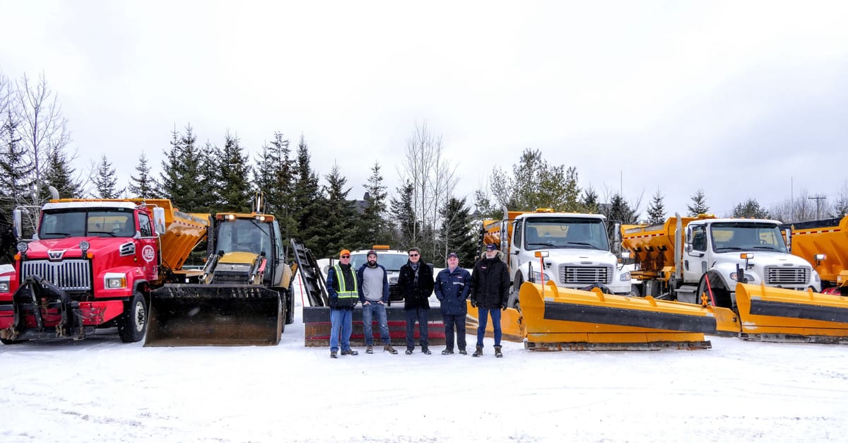 Devant la machinerie des Entreprises Doménick Sigouin, avec Bobby Racico et Yan Berlinguette, le maire Paul Germain le contre