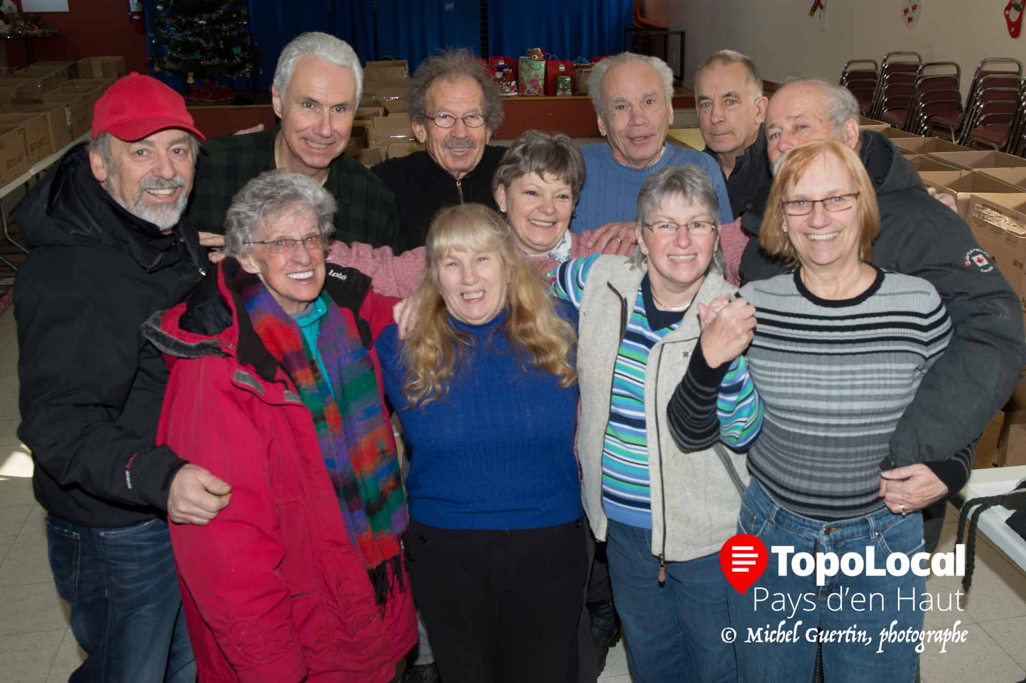 Toujours impliquée, elle aura été un pilier de l'organisme Objectif Partage qui lui tenait très à coeur. Sur la photo, elle est accompagnée de bénévoles lors de la distribution de paniers de Noël en 2013.