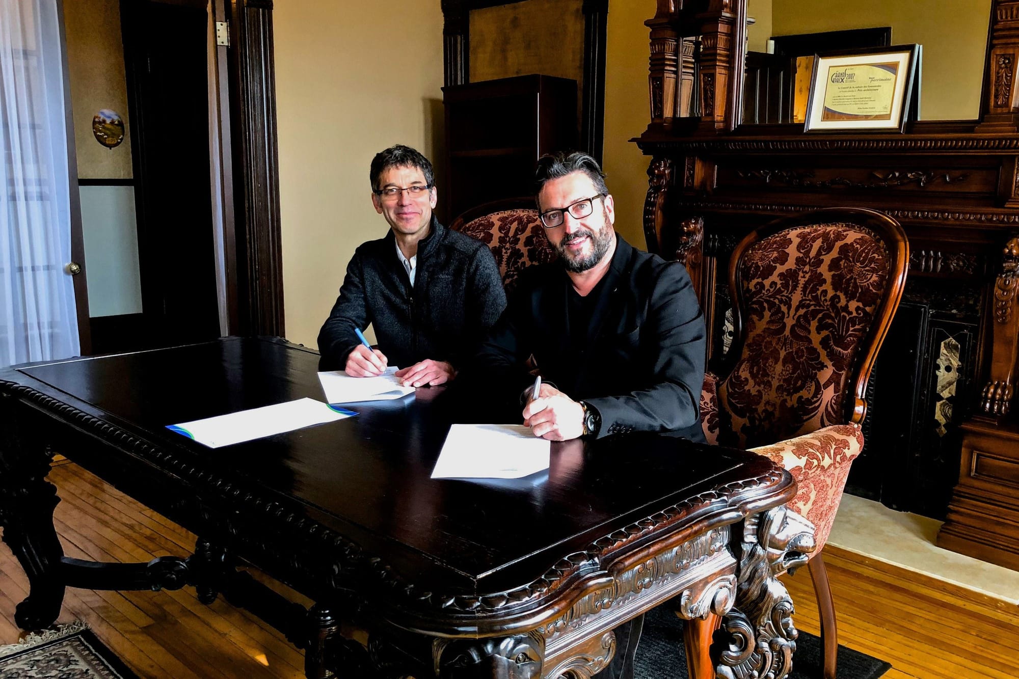 Roger Hotte, directeur général de la MRC et Bruno Laroche, préfet de la MRC et maire de Saint-Hippolyte, signant l'acte de vente de la Maison Prévost, le 30 avril 2018, à la Maison Prévost.